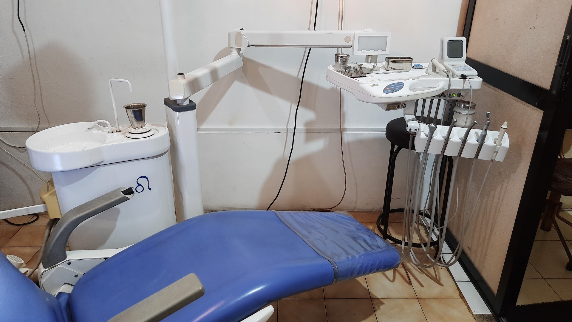 Blue dental chair and treatment equipment inside the clinic