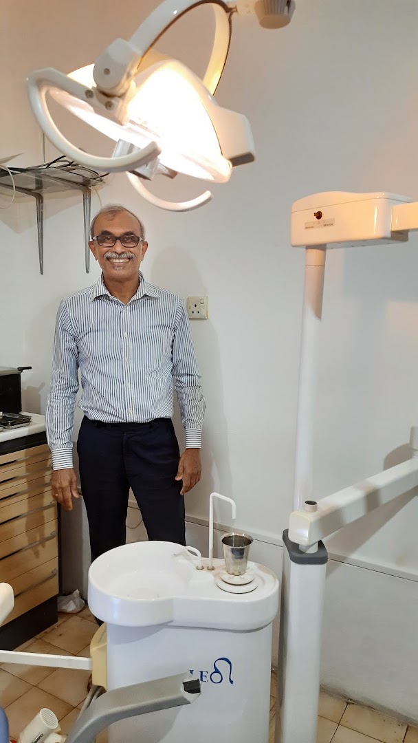 Dr. Upali Piyadigama standing in the clinic treatment room